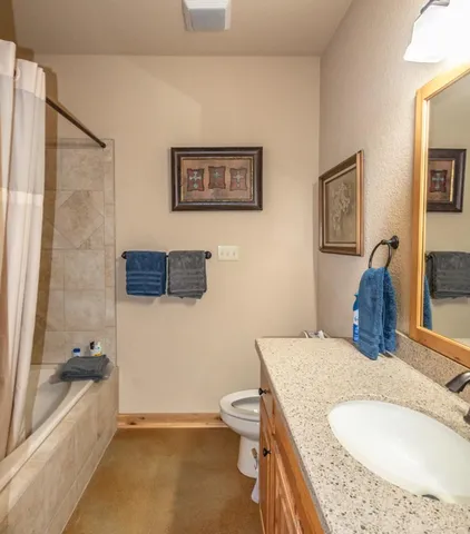 a bed room with a bed and a chair