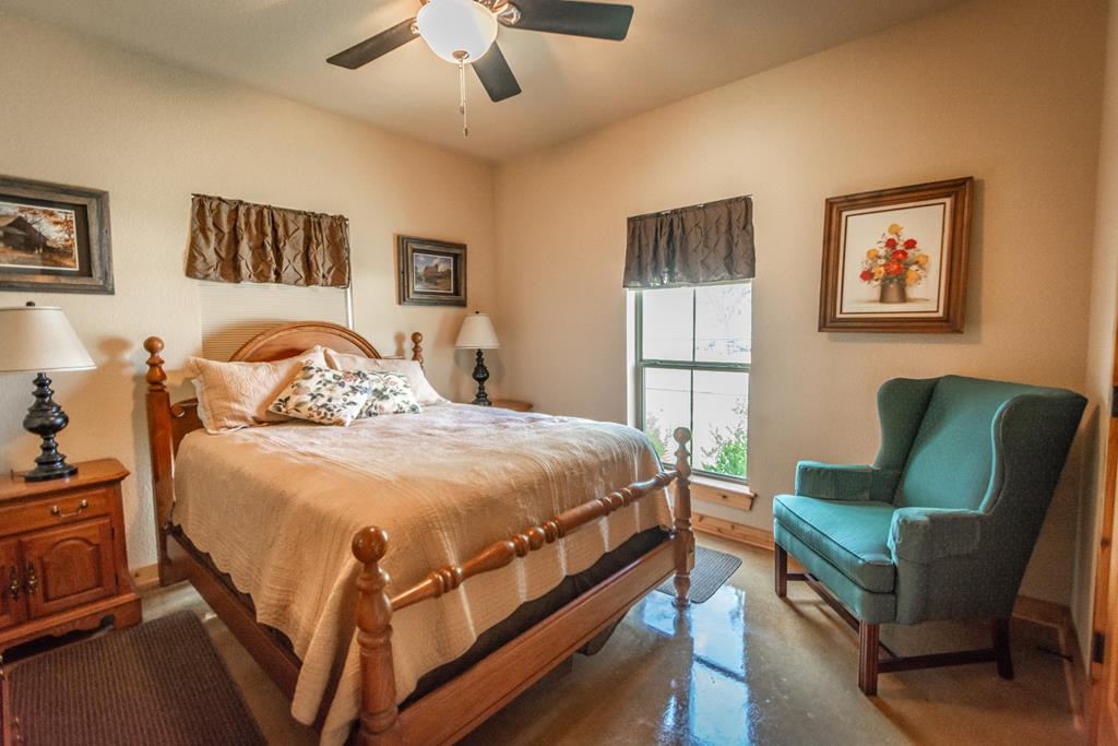 2657 West Sabinal Road Utopia, TX 78884 - Photo 33 of 36 a bed room with a bed and a chair