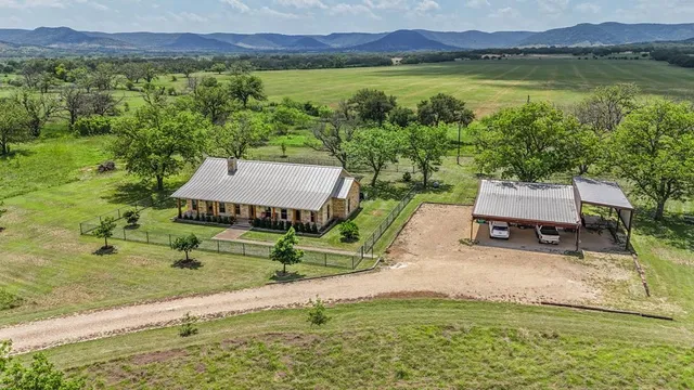 an aerial view of a house with mountain view