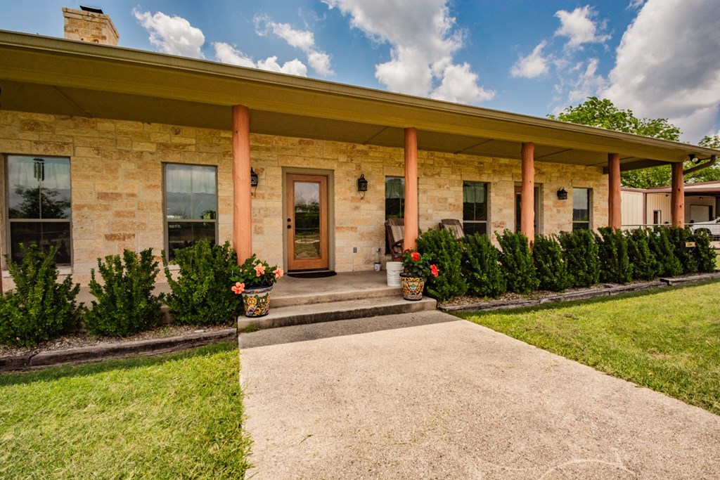 2657 West Sabinal Road Utopia, TX 78884 - Photo 5 of 36 a view of a house with potted plants and a table and chairs