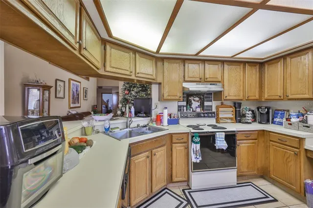 a kitchen with a sink stove and cabinets