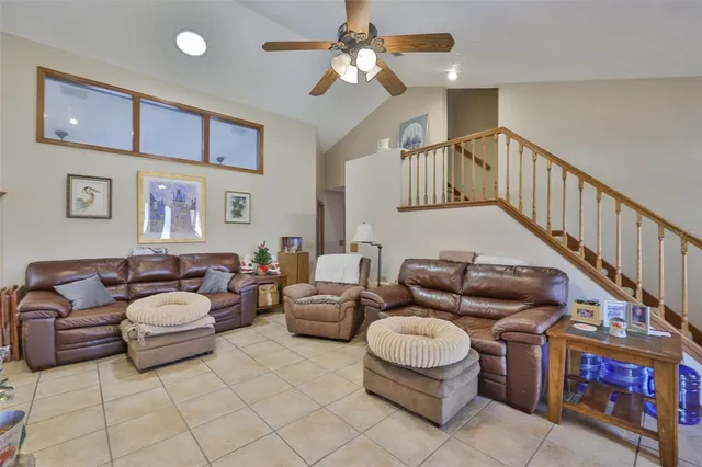a living room with furniture and stairs