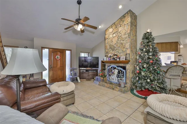 a living room with furniture a chandelier and a fireplace
