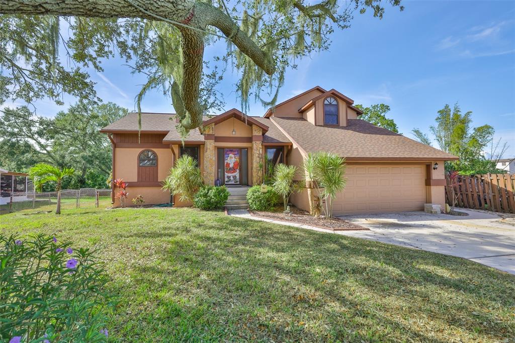 411 12th Street Southwest Ruskin, FL 33570 - Photo 2 of 33 a front view of house with yard and green space