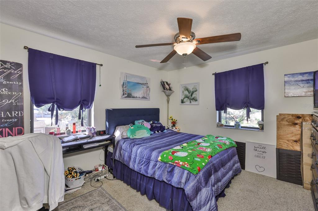 411 12th Street Southwest Ruskin, FL 33570 - Photo 25 of 33 a bedroom with a bed table and chair