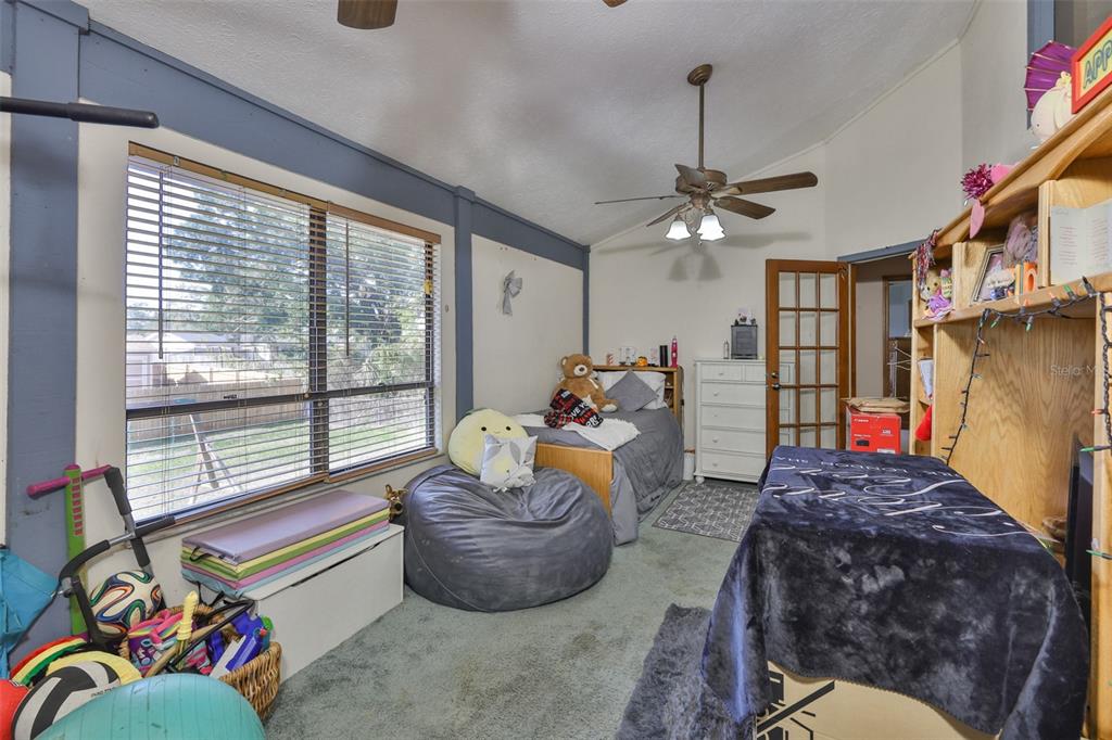 411 12th Street Southwest Ruskin, FL 33570 - Photo 28 of 33 a living room filled with furniture and a chandelier