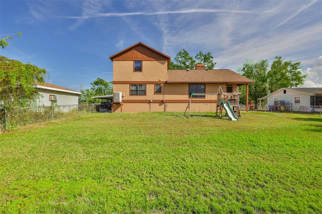 411 12th Street Southwest Ruskin, FL 33570 - Photo 3 of 33 a view of a house with a yard