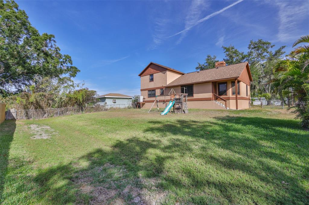 411 12th Street Southwest Ruskin, FL 33570 - Photo 5 of 33 a front view of a house with garden