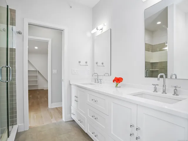a bathroom with double sink and a mirror