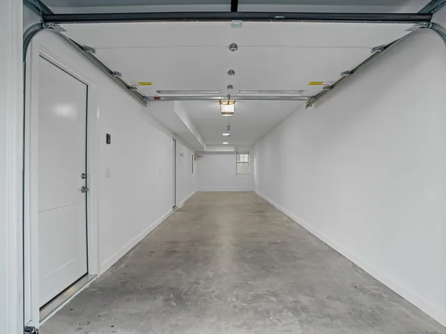 a view of a big room with chandelier and windows