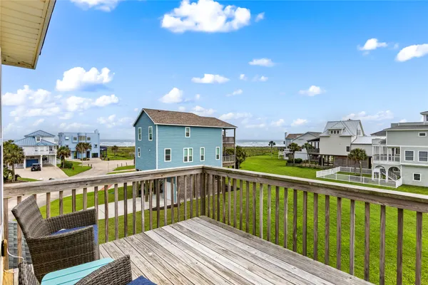 a view of a balcony with wooden floor and fence