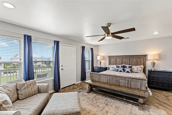 a bedroom with a bed couch and window