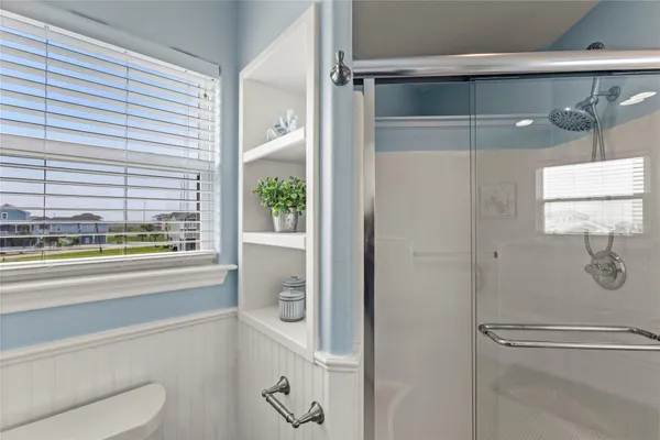 a bathroom with a shower and a sink