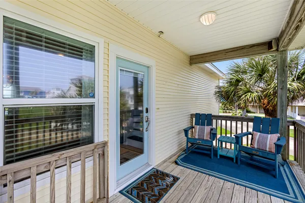 a view of a two chairs in the balcony