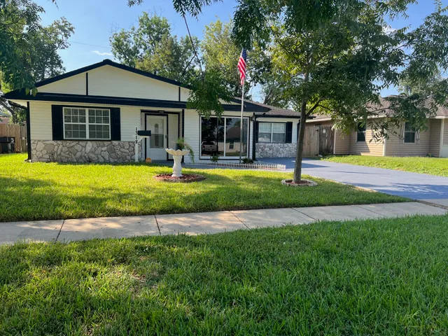 a front view of a house with a yard and porch