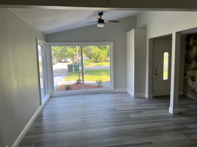a view of a room with a window and chandelier