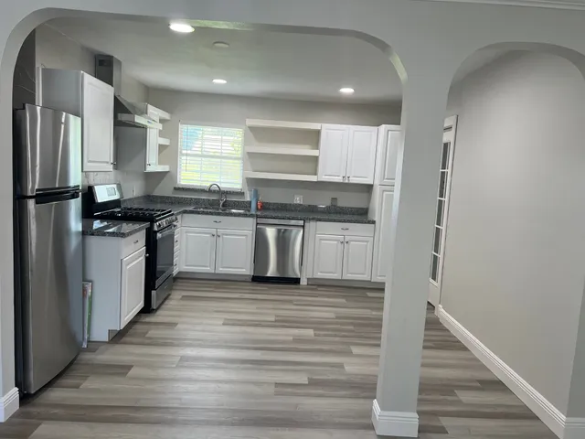 a view of a house with a yard and sitting area