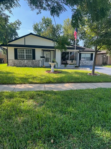 a front view of house with yard and green space