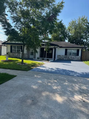a view of a house with swimming pool and a yard