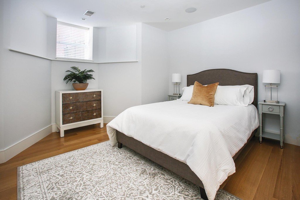 373 Harvard Street, Unit 2 Brookline, MA 02446 - Photo 5 of 7 a bedroom with a bed and a dresser