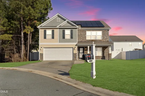 a front view of a house with a yard
