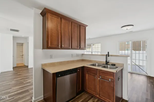 a kitchen with stainless steel appliances granite countertop a sink a stove and a refrigerator