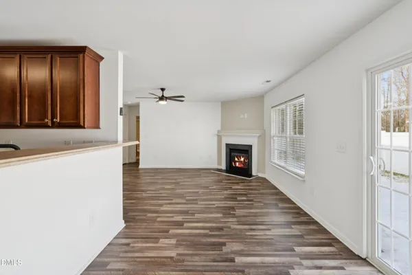 a kitchen with a sink cabinets and wooden floor