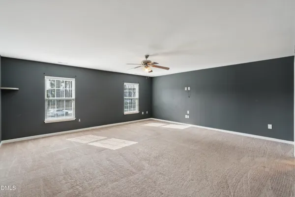 a view of empty room with wooden floor and fireplace