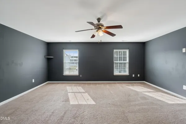 a view of a livingroom with a ceiling fan and window
