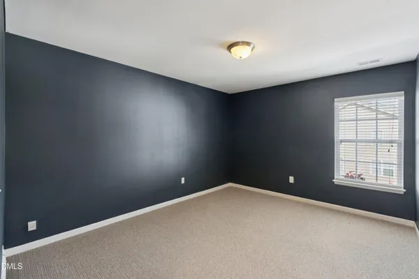 a bathroom with a bathtub shower sink vanity mirror and toilet