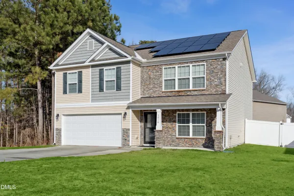 a bedroom with bed couch and window