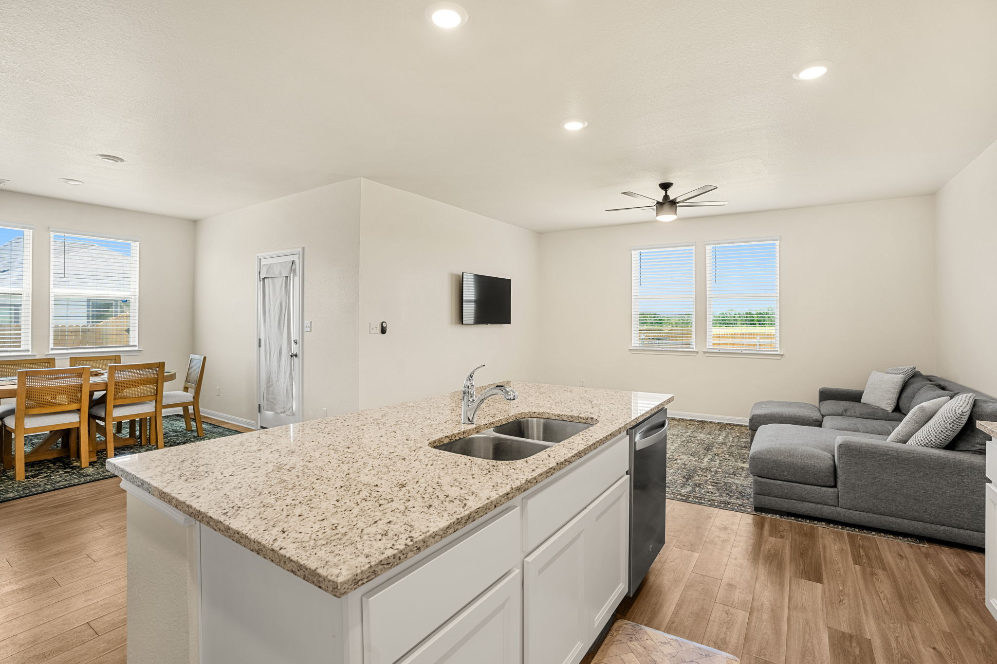148 Hidalgo Lane Elgin, TX 78621 - Photo 2 of 38 An open concept design seamlessly connects the kitchen to the living and dining areas, creating an inviting flow.
