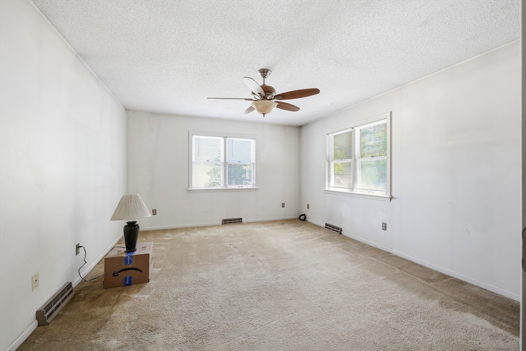 19-21 Wedgewood Circle Springfield, MA 01129 - Photo 16 of 32 an empty room with ceiling fan and windows