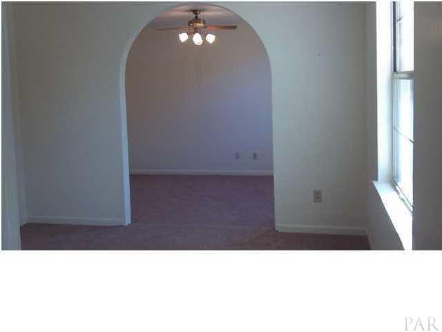 5376 Persimmon Hollow Road Milton, FL 32583 - Photo 4 of 12 Step down through the Arched Opening into the bedroom area, has HUGE walk-in closet, additional closet, and ceiling fan. Lots of natural light, spacious area for complete bedroom retreat.