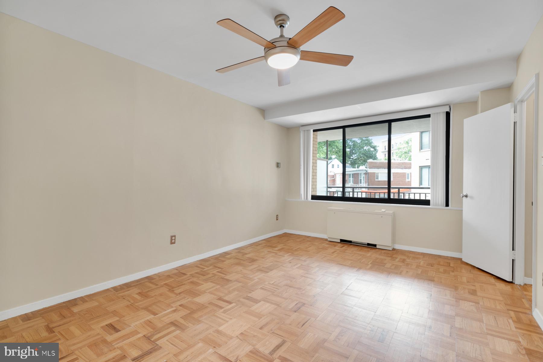 4740 Connecticut Avenue Northwest, Unit 414 Washington, DC 20008 - Photo 15 of 33 an empty room with windows and ceiling fan