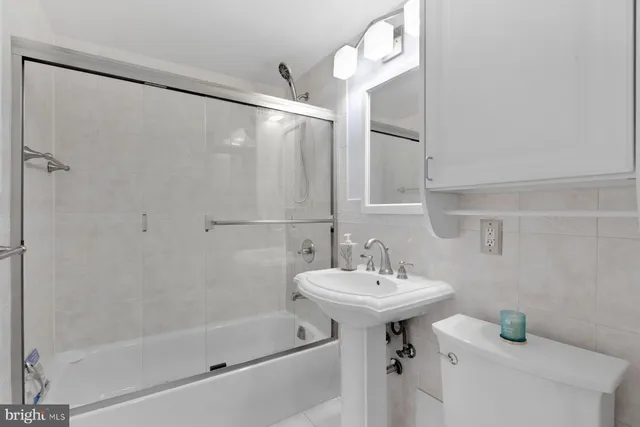 a bathroom with a sink a mirror and a bathtub