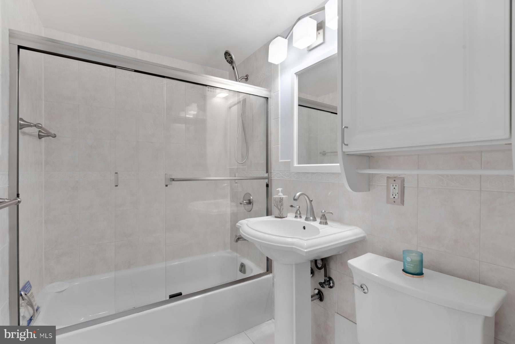 4740 Connecticut Avenue Northwest, Unit 414 Washington, DC 20008 - Photo 16 of 33 a bathroom with a sink a mirror and a bathtub