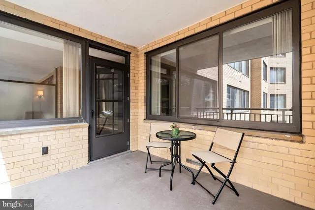 a balcony with table and chairs