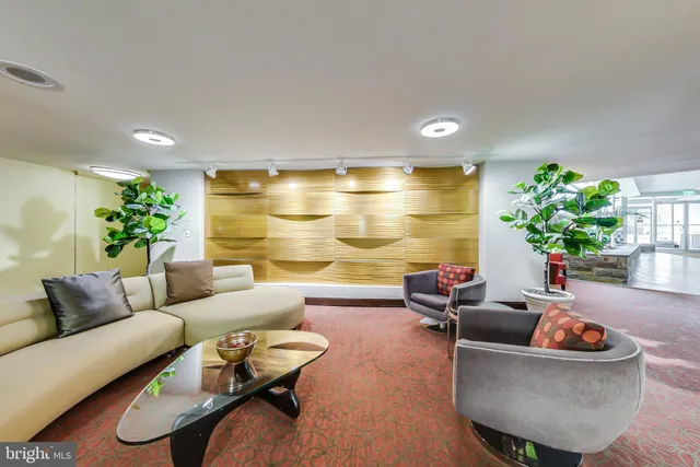 a living room with furniture and flowers