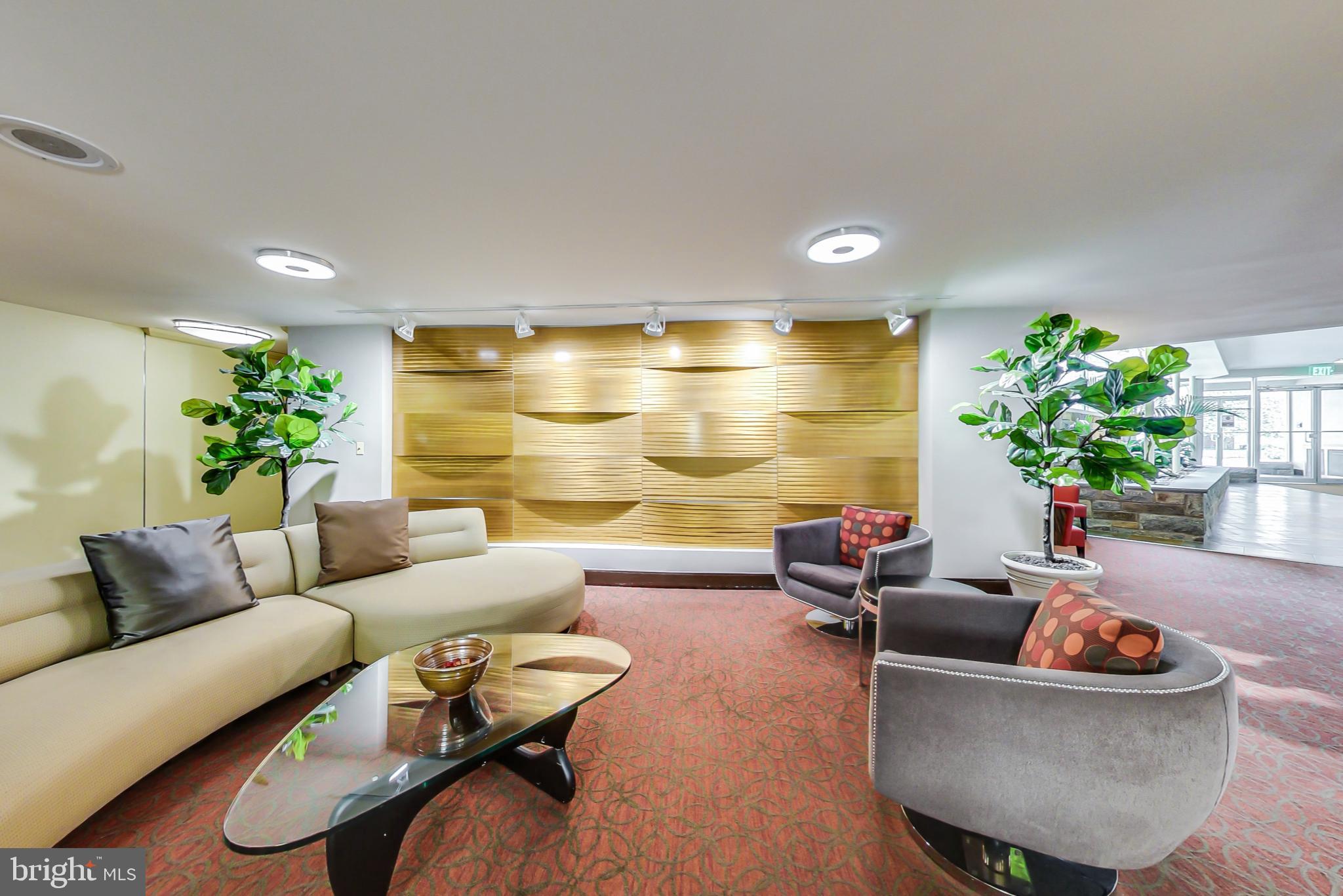 4740 Connecticut Avenue Northwest, Unit 414 Washington, DC 20008 - Photo 26 of 33 a living room with furniture and flowers