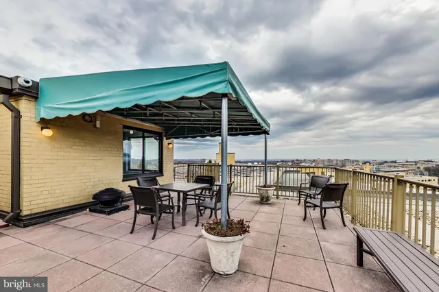 a view of a patio with chairs and potted plants