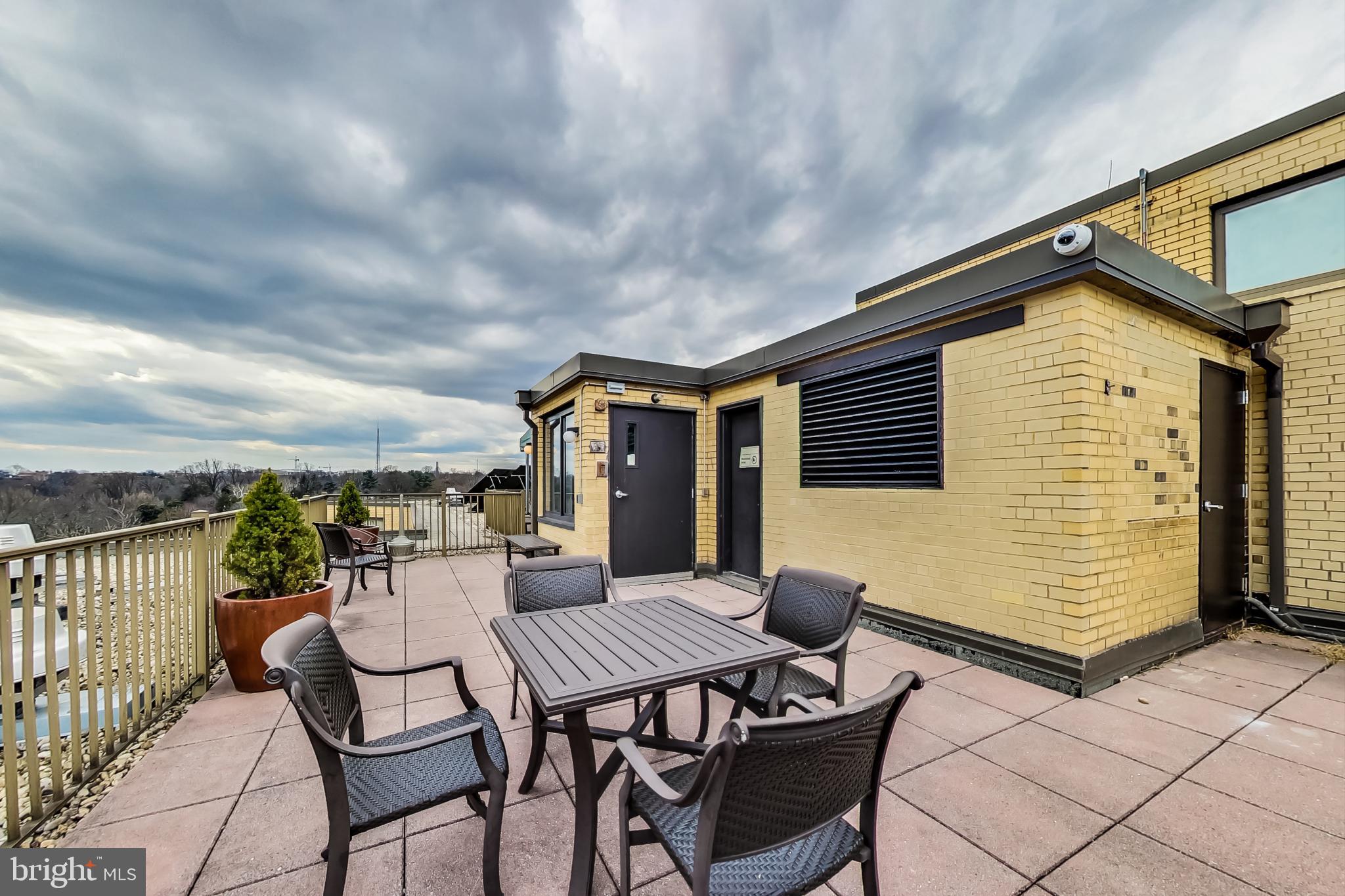 4740 Connecticut Avenue Northwest, Unit 414 Washington, DC 20008 - Photo 30 of 33 a roof deck with a table and chairs