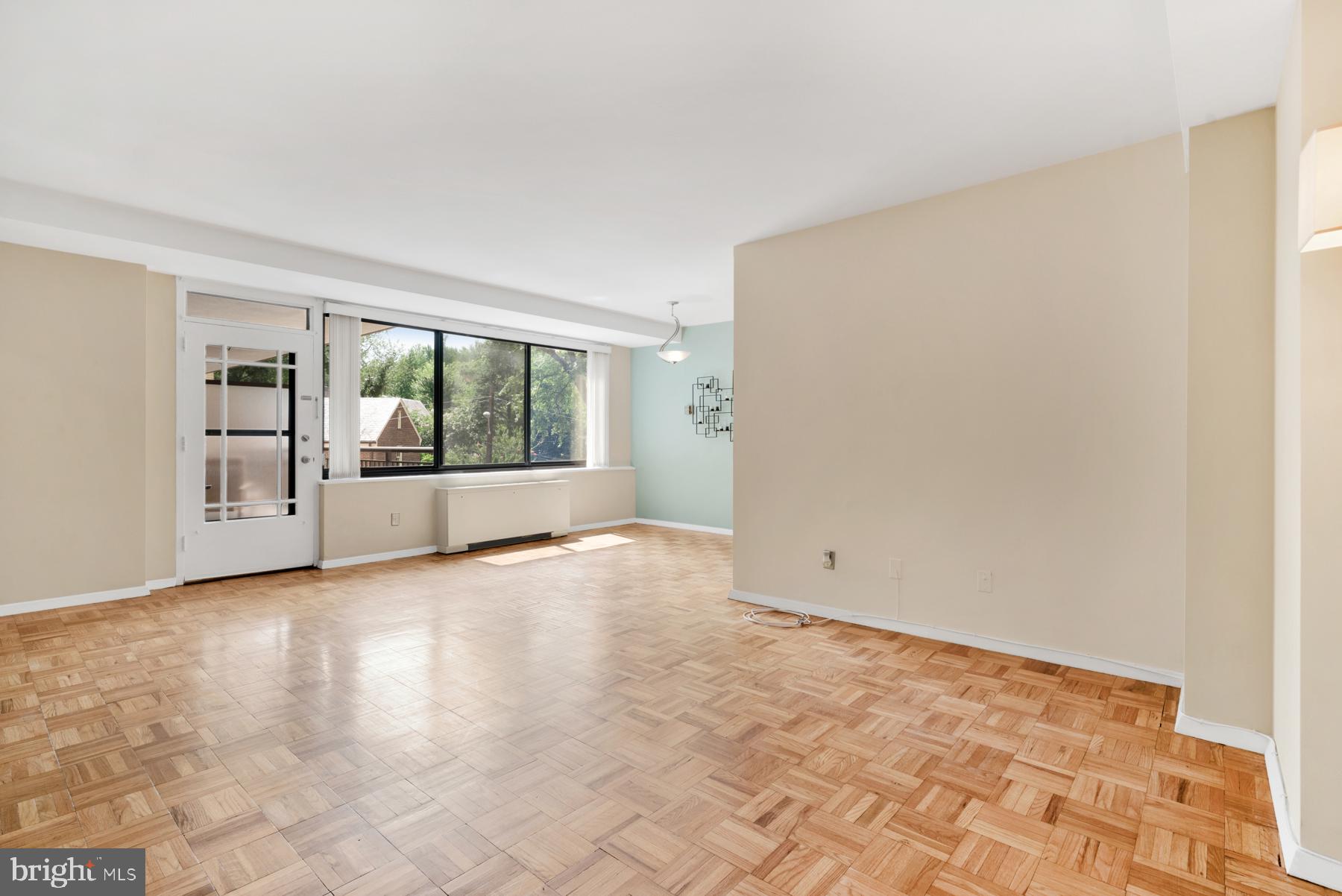 4740 Connecticut Avenue Northwest, Unit 414 Washington, DC 20008 - Photo 5 of 33 wooden floor in an empty room with a window