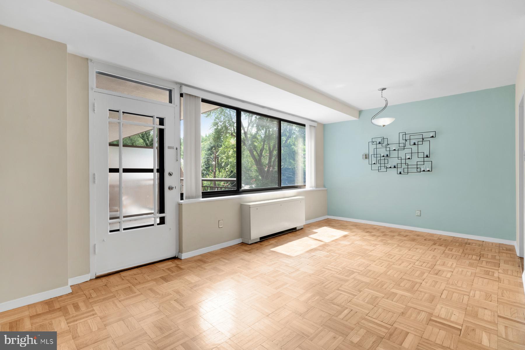 4740 Connecticut Avenue Northwest, Unit 414 Washington, DC 20008 - Photo 8 of 33 a view of an empty room with a window and a kitchen
