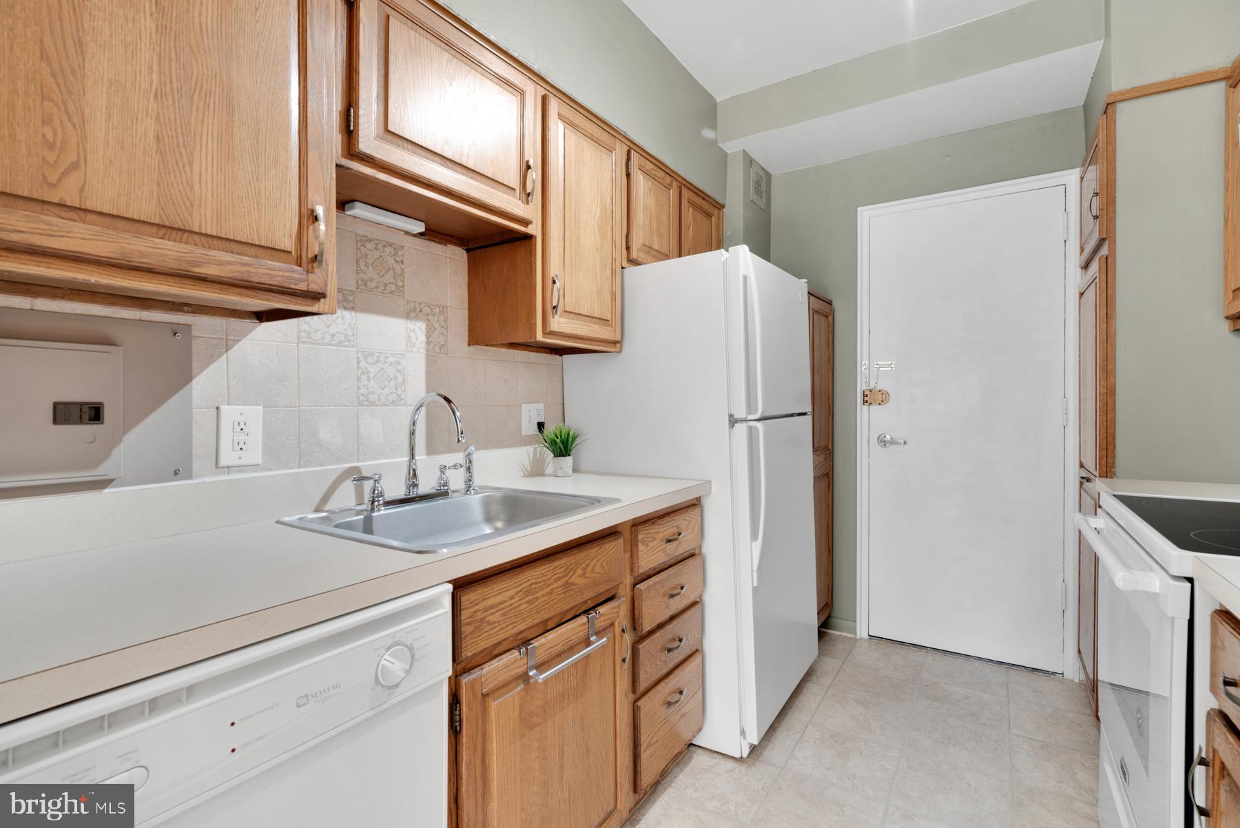 4740 Connecticut Avenue Northwest, Unit 414 Washington, DC 20008 - Photo 10 of 33 a kitchen with a sink and a refrigerator