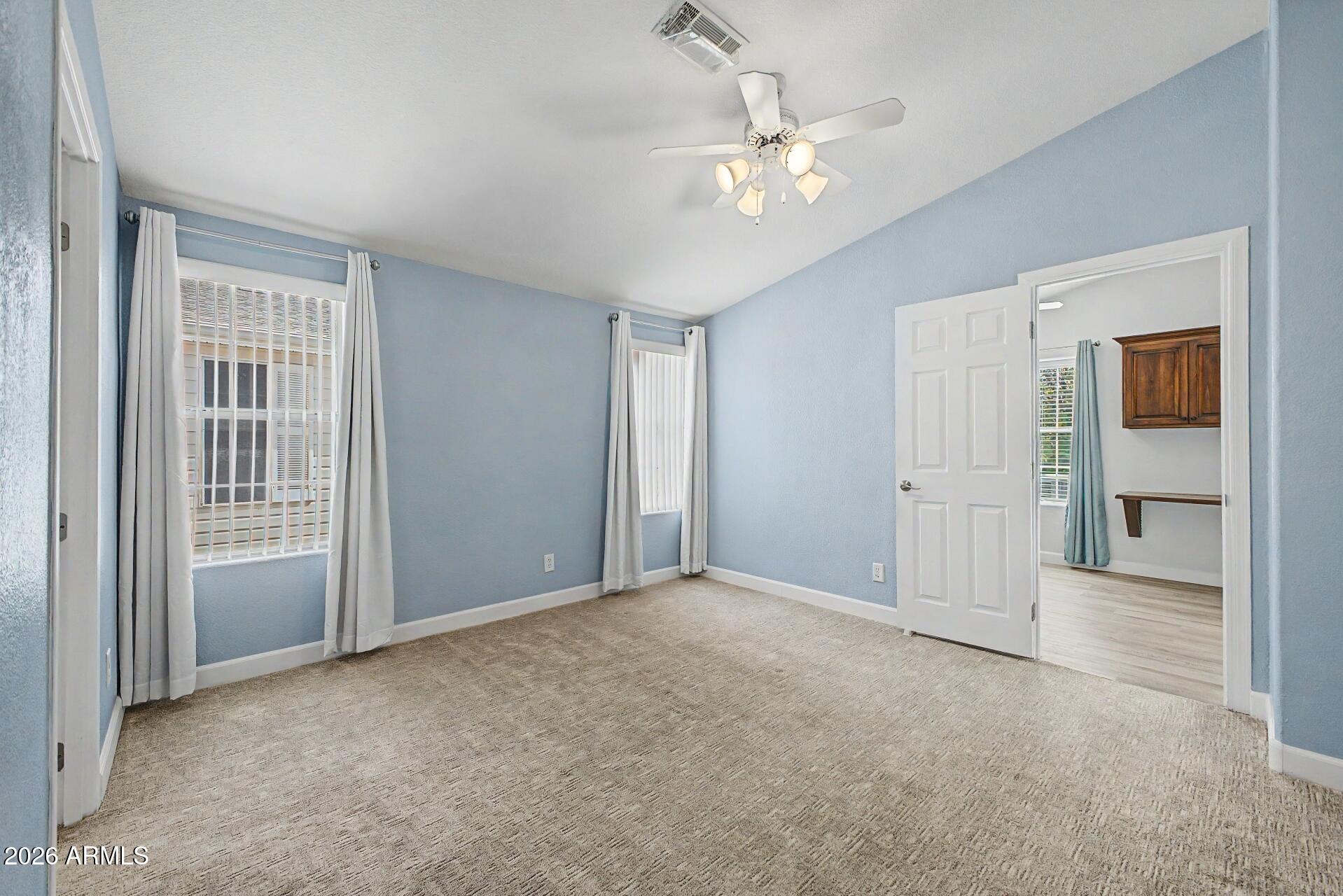 2550 South Ellsworth Road, Unit 50 Mesa, AZ 85209 - Photo 12 of 45 a view of an empty room with chandelier fan