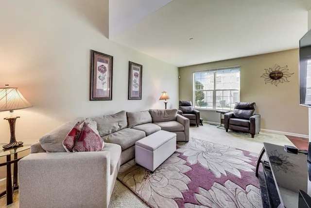 a living room with furniture ceiling fan and a window