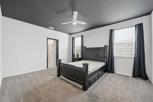 a bed room with a bed and a window
