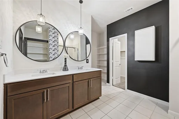 a bathroom with a double vanity sink and a mirror
