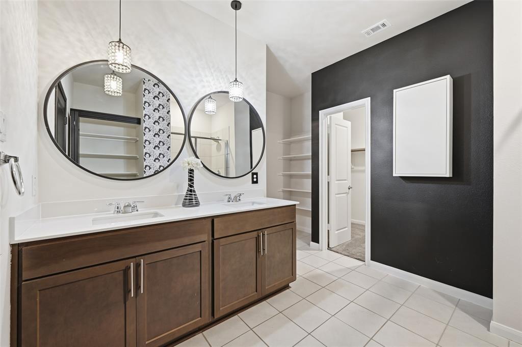 617 Range Drive Princeton, TX 75407 - Photo 13 of 26 a bathroom with a double vanity sink and a mirror